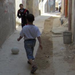 Palestinian boys playing footballl in al-Amari refugee camp